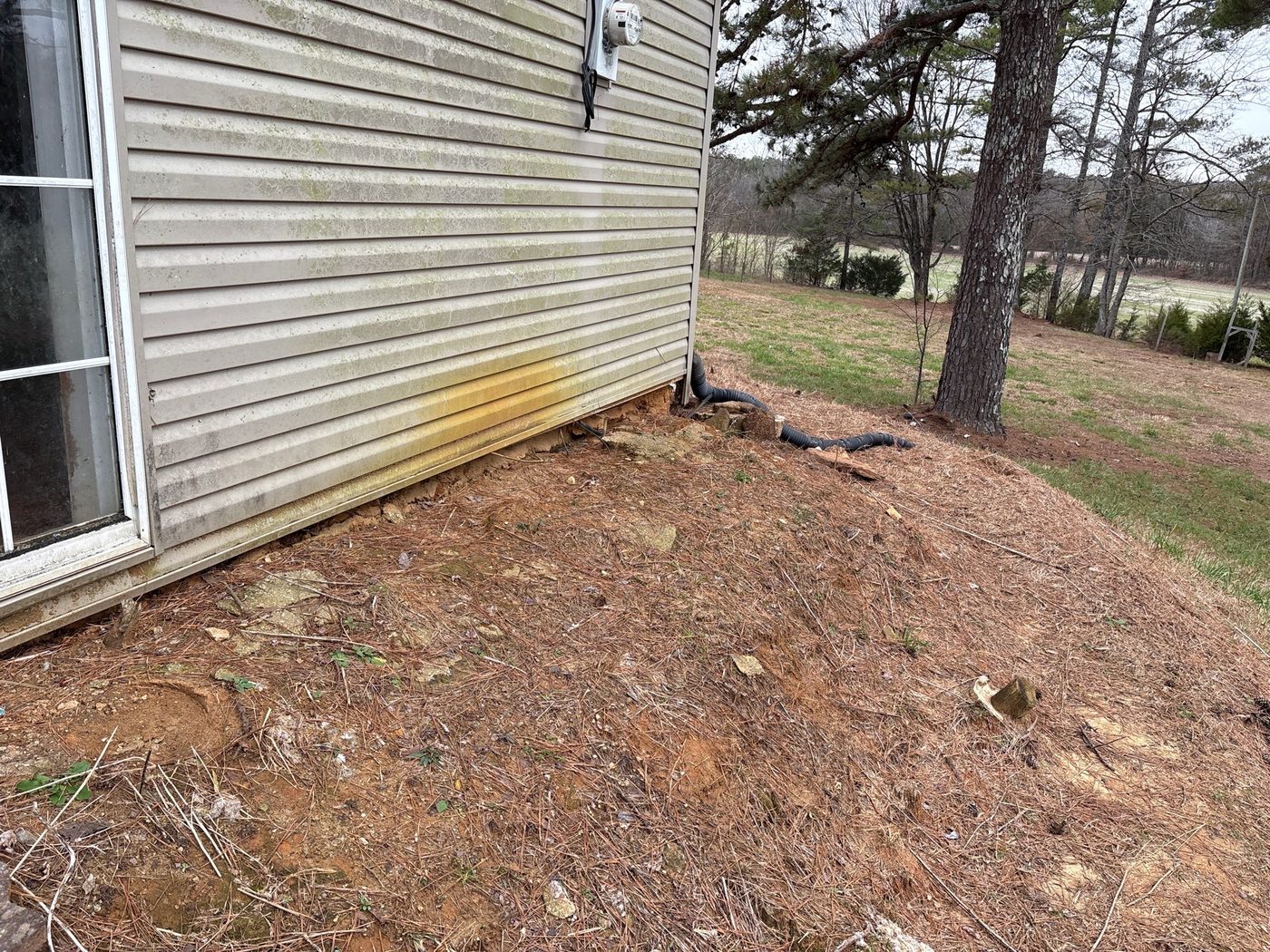Electric meter and service entrance on the side of a home