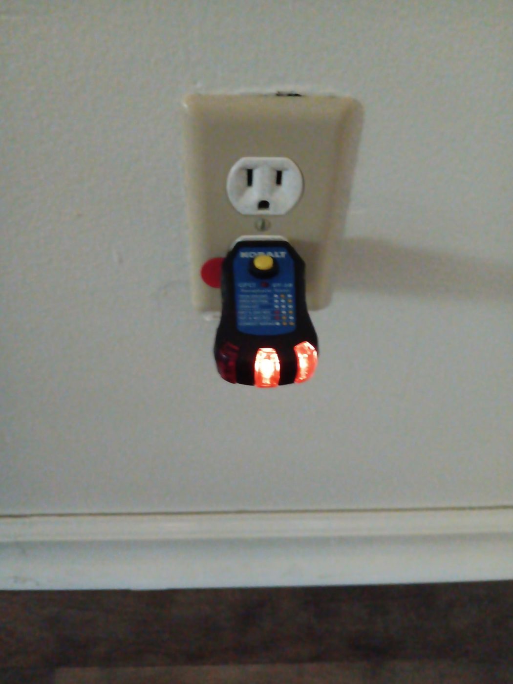 GFCI receptacle tester in use during a diagnostic visit